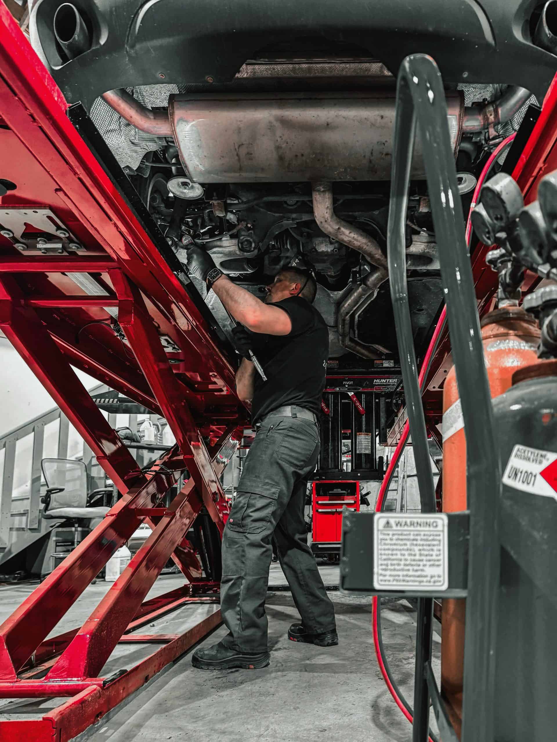 Mike Hayes working under a vehicle